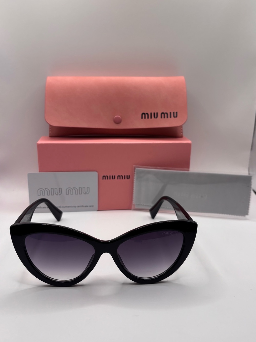 Miu Miu Black Cat-Eye Sunglasses with Purple Gradient Lenses